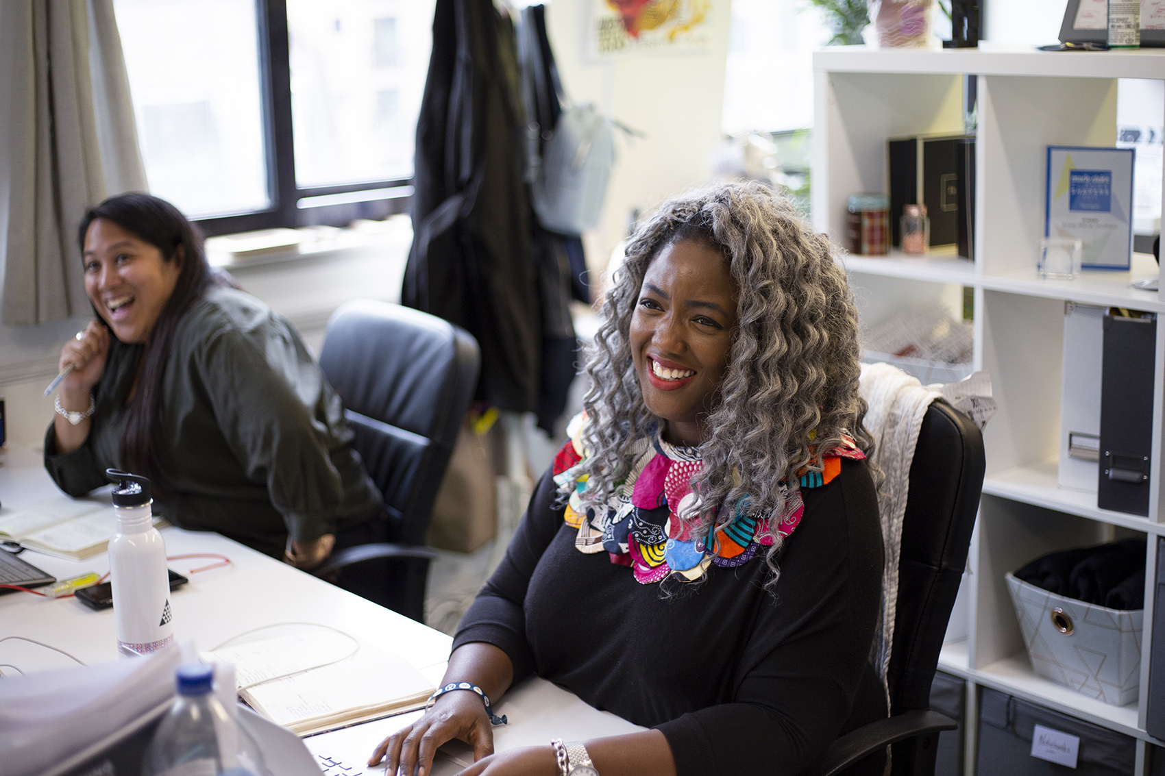 A smiling Anne-Marie Imafidon (Keble, 2006) working in her office