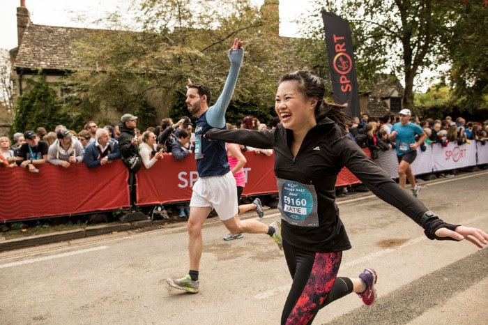 Katie Myint, Oxford half finish line Katie Myint running with her arms out stretched at the end a race, looking very pleased