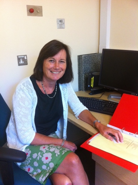 Lucy Johnstone sat at a desk with an open file