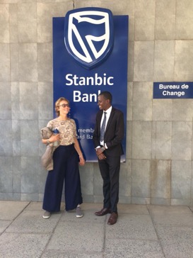 Michelle rorich bank Michelle stood with a man next to a sign for 'Stanbic Bank'