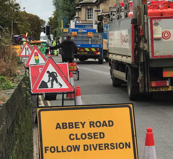 Road works and a sign saying 'Abbey Road closed, follow diversion'