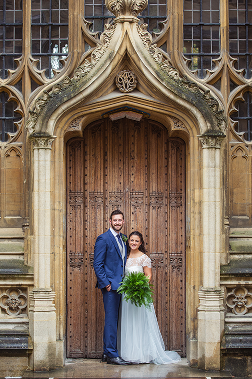 Alex Woods and Zoe de Toledo, on their wedding day, in an ornate doorway to the Bodleian Library