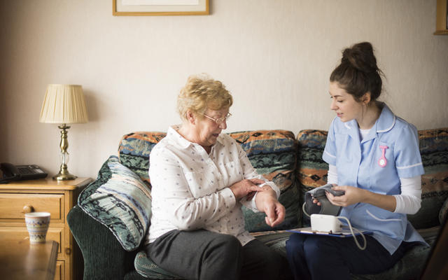 A resident being treated by a nurse in a UK Care Home