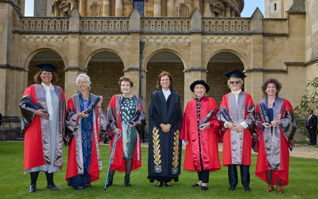 Six honorary degree recipients stand with the Vice-Chancellor at Encaenia, 2021