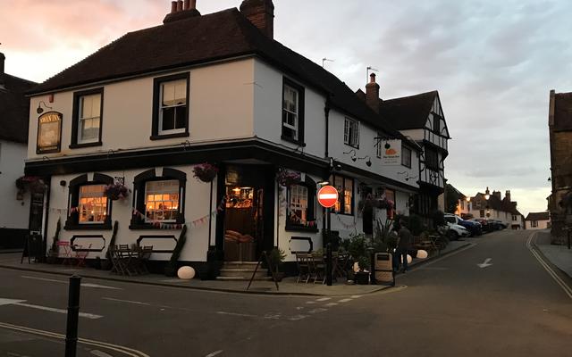 The Swan Pub, Midhurst, West Sussex. Shown at dusk with lighted windows.