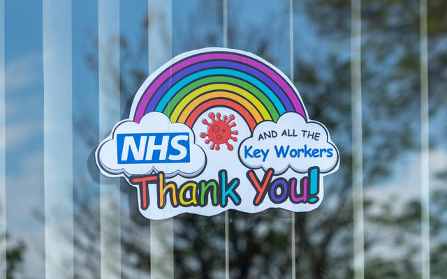 A sticker in a window, with a rainbow and a message saying 'thank you NHS and all the key workers'