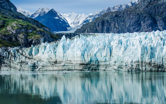 Close-up of Margerie Glacier in Glacier Bay National Park and Preserve in Southeast Alaska which is twenty-one miles long and one mile wide with layers of rock debris mixed with ice