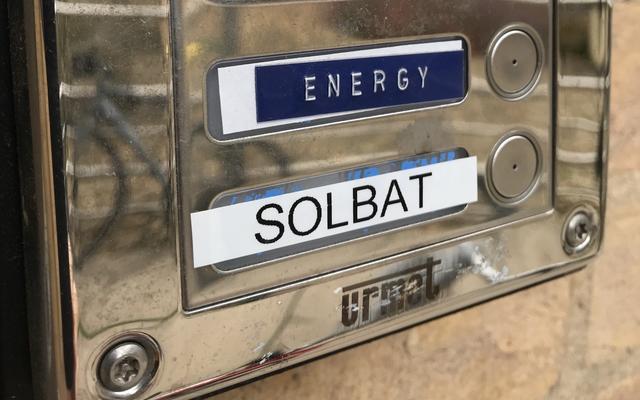 An intercom system on the outside of a building, with 'Dept of Materials' at the top, and two buttons below, one for calling 'ENERGY', the other for 'SOLBAT'