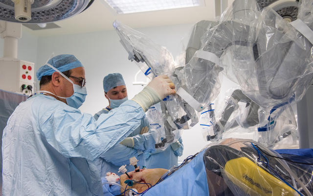 Two doctors using The Da Vinci robotic platform to perform colorectal surgery