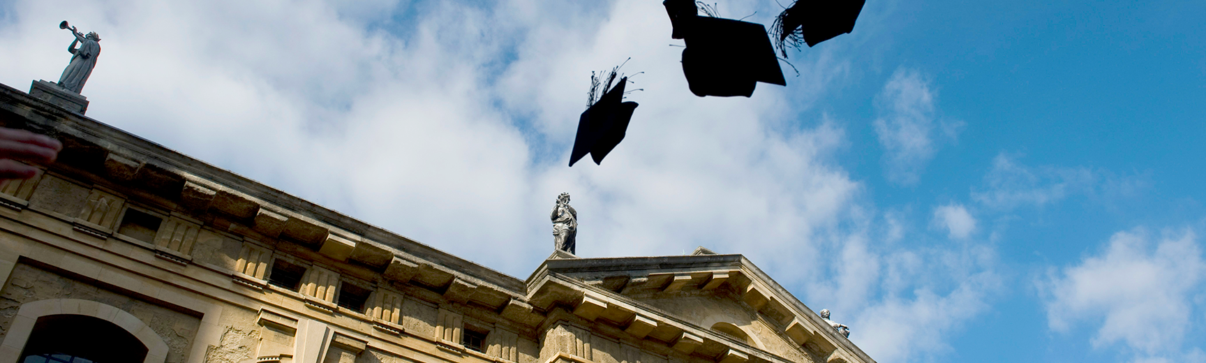 Mortar boards in the air above Sheldonian