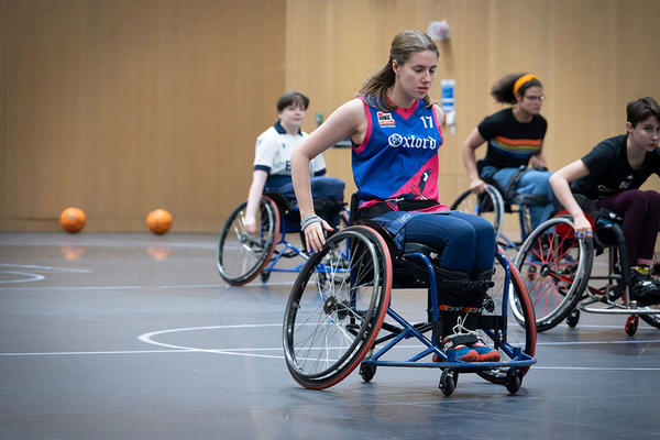 Members of the Oxford Kites WBC using their specialist sports wheelchairs on the basketball court