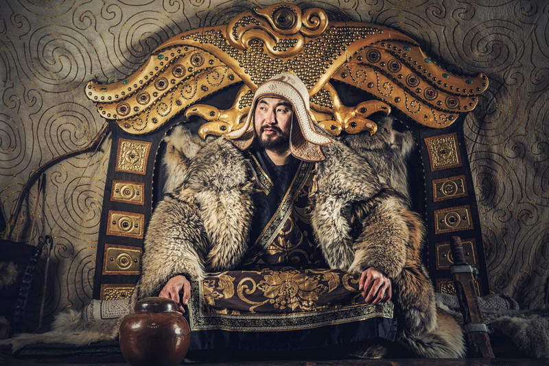 A recreation of Genghis Khan, sat on a throne