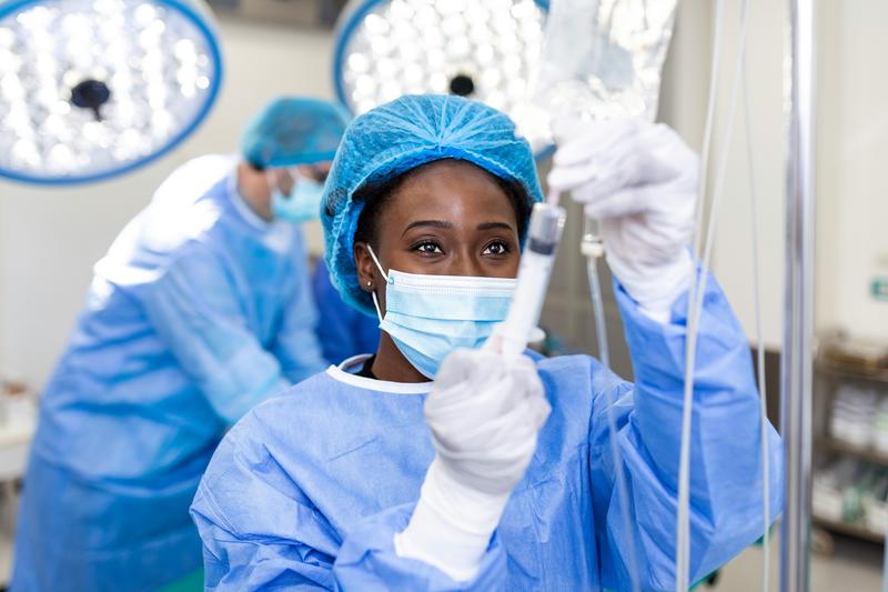 Female health worker in protective lab clothing