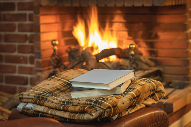 Books in front of a log fire