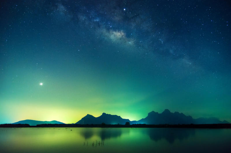 Night scene with the Milky Way reflecting on a pond. Prachuap Khiri Khan Province, Thailand