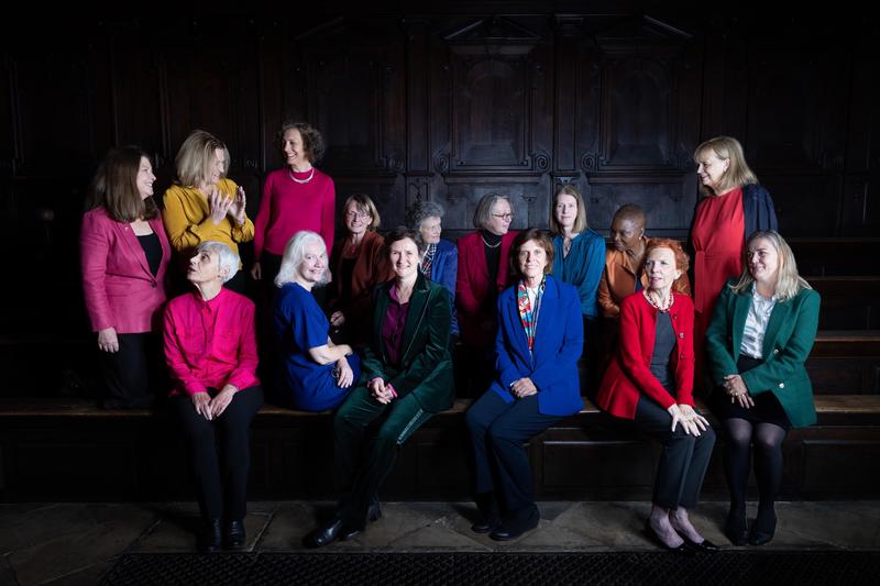A group of colourfully dressed women in Oxford, titled 'Oxford Women'