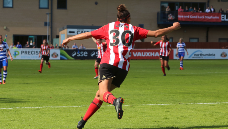 Beverly Leon, playing for Sunderland, celebrating a goal, with team mates running towards her