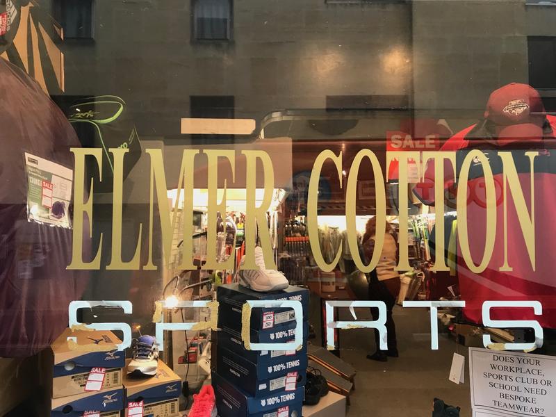 Looking through the window of Elmer Cotton Sports, with the name printed on the window
