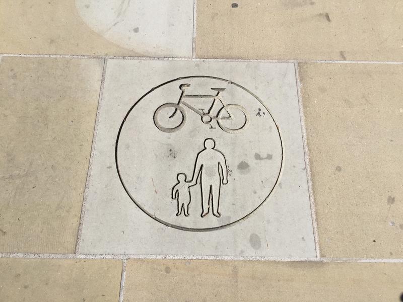A sign on the pavement of Frideswide Square, indicating shared cycle and pedestrian use