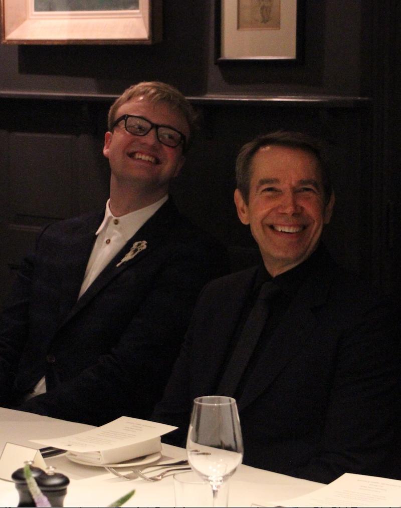 Oli Lloyd-Parry and Jeff Koons, seated at a dining table