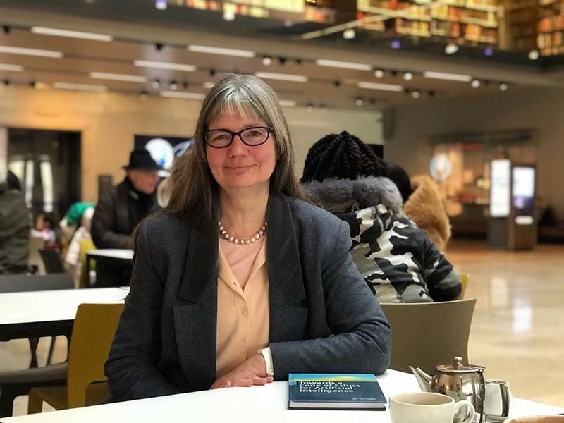 Paula Boddington sat at a cafe table in the Weston Library