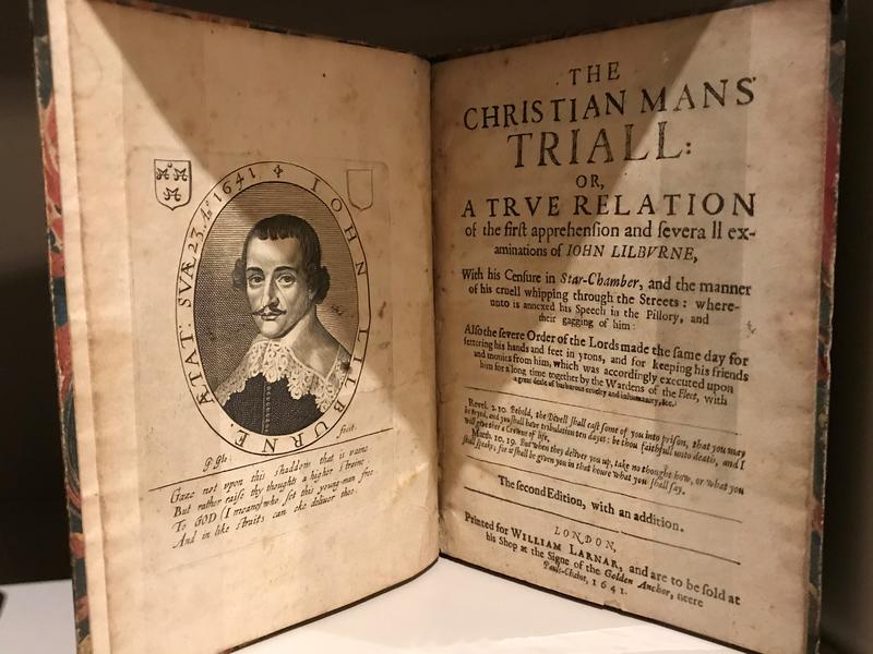 An old, open book, showing a page titled 'The Christian Mans' Triall' (sic)