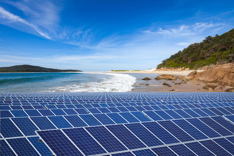 A bank of solar panels on a beach