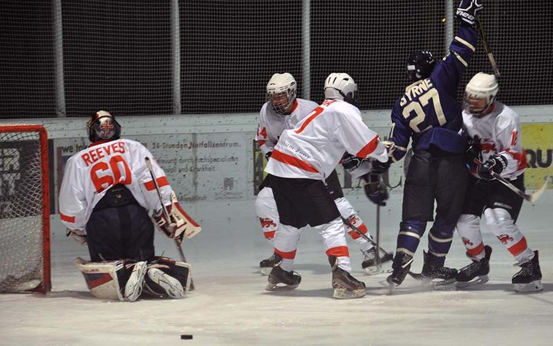 An ice hockey match in progress, and Byrne, number 27, is surrounded by opposing players