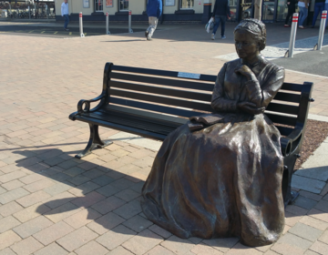 A bronze statue of Charlotte Mary Yonge that is in Eastleigh