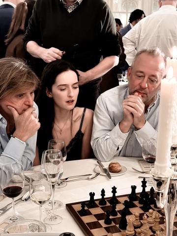 Anoushka Rowland-Payne (centre) plays chess with Dave Norwood (right)