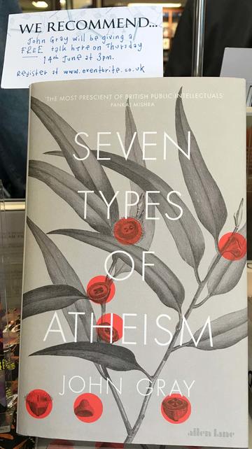 A window display with the cover of 'Seven types of atheism' by John Gray beneath a note giving details of John's talk on the book