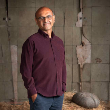 Professor Yadvinder Malhi poses with a sea coconut