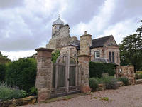 A view of Biddulph Old Hall with the entrance gates in the foreground